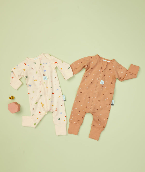 Flatlay of ergoPouch Long Sleeve Romper 0.2 TOG Critters and Honey Bees