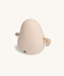 Rear view of a soft-touch silicone bedtime lamp shaped like a rounded character with small arms and legs, showing a charging port at the base.
