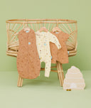 Product shots of ergoPouch Cocoon Swaddle Sack 0.2 TOG Honey Bees, Long Sleeve Romper Critters, and Short Sleeve Romper Honey Bees