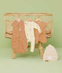 Product shots of ergoPouch Cocoon Swaddle Sack 0.2 TOG Honey Bees, Long Sleeve Romper Critters, and Short Sleeve Romper Honey Bees