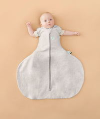 Baby sleeping with arms out in a ergoPouch Hip Harness Cocoon Swaddle Sack 1.0 TOG Grey Marle