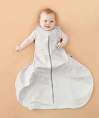 Smiling baby wearing with hip dysplasia wearing a ergoPouch Hip Harness Sleep Sack 1.0 TOG Grey Marle