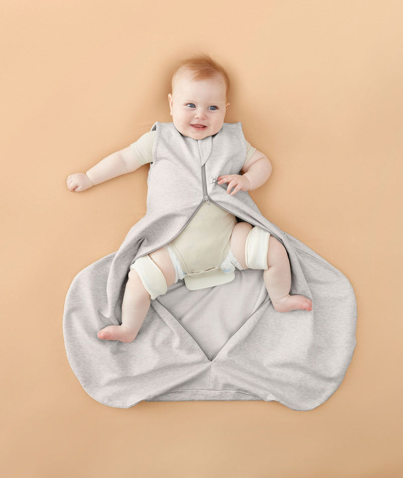 Baby in ergoPouch Hip Harness Sleep Sack 1.0 TOG Grey Marle, with legs open from hip dysplasia