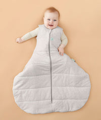 Smiling baby with hip dysplasia wearing a ergoPouch Hip Harness Sleep Sack 2.5 TOG Grey Marle
