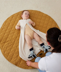 Baby in ergoPouch Hip Harness Sleep Sack 1.0 TOG Oatmeal Marle, with hip dysplasia