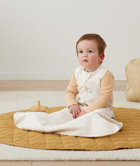 Baby in ergoPouch Hip Harness Sleep Sack 1.0 TOG Oatmeal Marle, with hip dysplasia