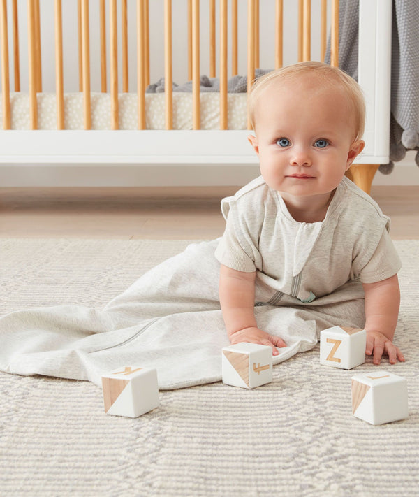 Infant playing with blocks wearing a light Sleep Sack 0.2 TOG Grey Marle