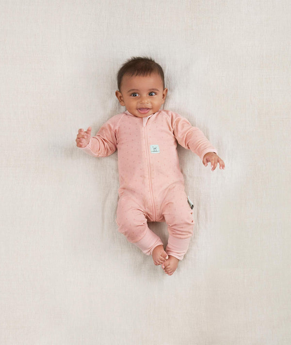 Newborn wearing an ergoPouch Long Sleeve Romper 1.0 TOG Berries