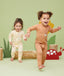 Two toddlers playing in ergoPouch Long Sleeve Romper 0.2 TOG Honey Bees and Critters