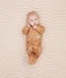 Newborn wearing ergoPouch Long Sleeve Romper 0.2 TOG Honey Bees