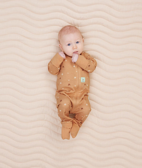 Newborn wearing ergoPouch Long Sleeve Romper 0.2 TOG Honey Bees