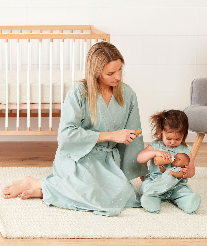 Mom wearing a an ergoPouch Matchy Matchy Robe Sage, playing with a toddler in a matching color Sleep Suit Sack