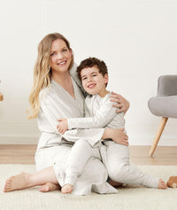 Mom embracing her toddler wearing an ergoPouch Matchy Matchy Robe Grey Marle