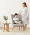 Mom wearing a an ergoPouch Matchy Matchy Robe Grey Marle, smiling down at child reading in a matching color Sleep Onesie