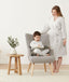 Mom wearing a an ergoPouch Matchy Matchy Robe Grey Marle, smiling down at child reading in a matching color Sleep Onesie
