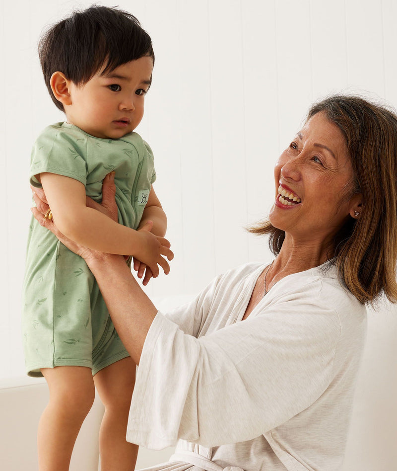 Mom wearing a an Mom wearing a an 2000, holding a child, holding a child