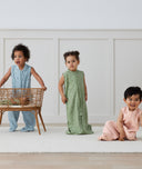 Three children playing in ergoPouch Jersey Sleep Suit Sack 0.2 TOG Willow, Dragonflies and Daisies, a light sleeping bag that converts to a sleeping bag with legs