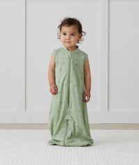 Child standing in ergoPouch Jersey Sleep Suit Sack 0.2 TOG Willow, a light sleeping bag that converts to a sleeping bag with legs