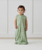 Child standing in ergoPouch Jersey Sleep Suit Sack 0.2 TOG Willow, a light sleeping bag that converts to a sleeping bag with legs