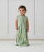 Child standing in ergoPouch Jersey Sleep Suit Sack 0.2 TOG Willow, a light sleeping bag that converts to a sleeping bag with legs