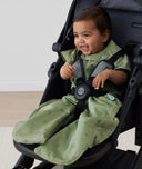 Child in a pram wearing ergoPouch Sleep Suit Sack 1.0 TOG Willow, a sleeping bag that converts to a sleeping bag with legs