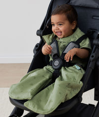 Child in a pram wearing ergoPouch Sleep Suit Sack 1.0 TOG Willow, a sleeping bag that converts to a sleeping bag with legs