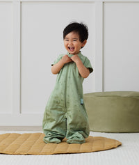 Toddler laughing, wearing an ergoPouch Sleep Suit Sack 1.0 TOG Willow