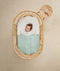 ergoPouch Drift Away White Noise Machine Taupe on table near cot