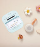 ergoPouch Drift Away White Noise Machine Taupe next to Room Thermometer and Dressing Guide, a soother and decorations