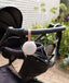 ergoPouch Drift Away White Noise Machine Taupe hanging from pram handle bar