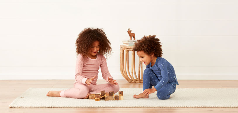 Two preschooler children playing calmly before bed