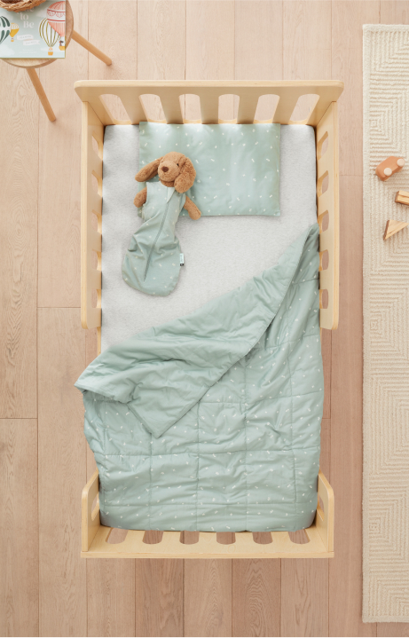 Toddler bed with pillow, blanket and soft toy