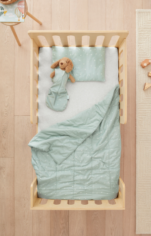 Toddler bed with pillow, blanket and soft toy