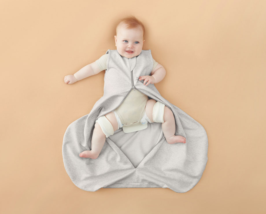 Baby with hip dysplasia wearing sleep sack with zipper open
