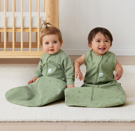 Two infants wearing Jersey sleep sacks in Willow, sleeved and sleeveless 